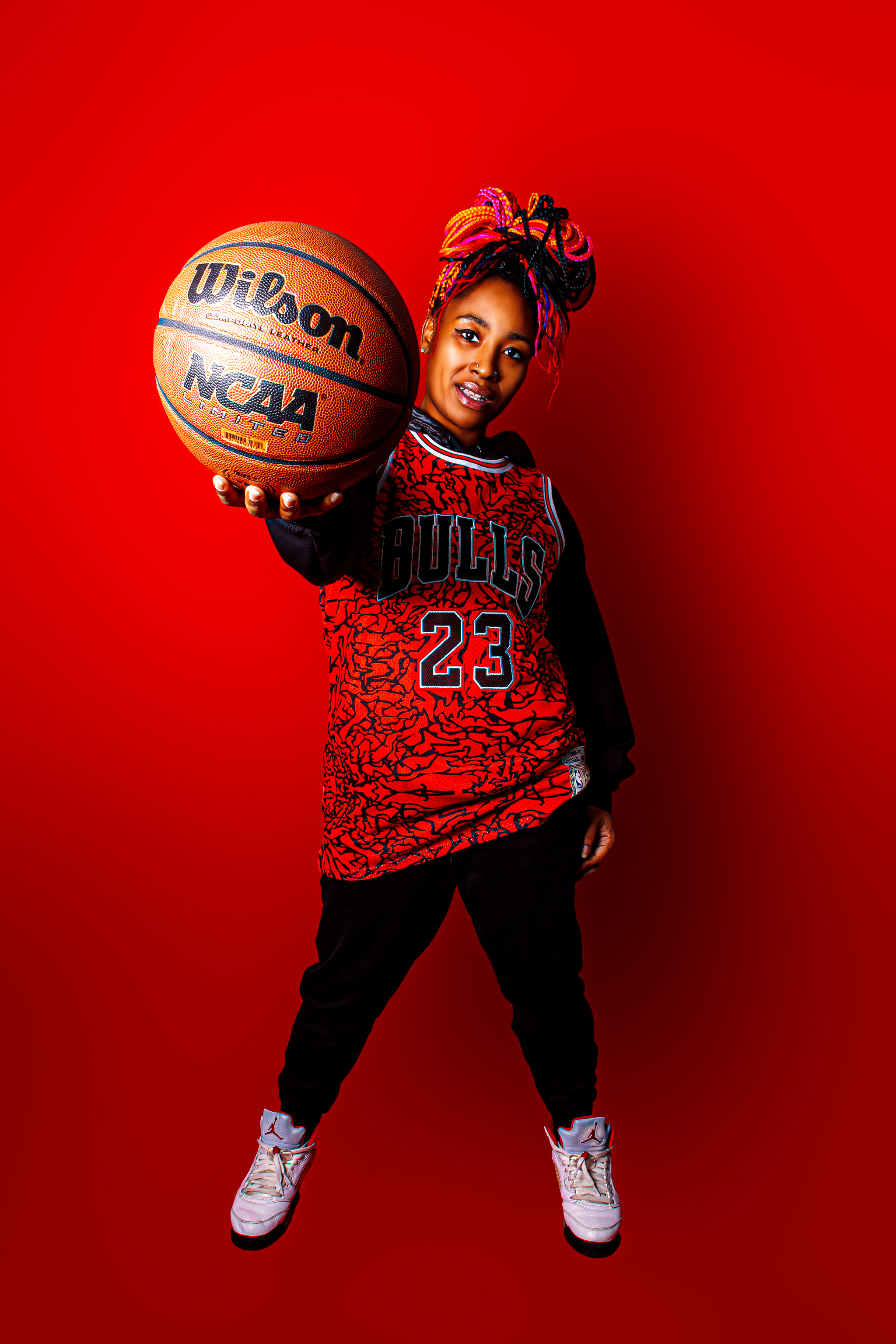 Basketball-inspired studio portrait against a red background