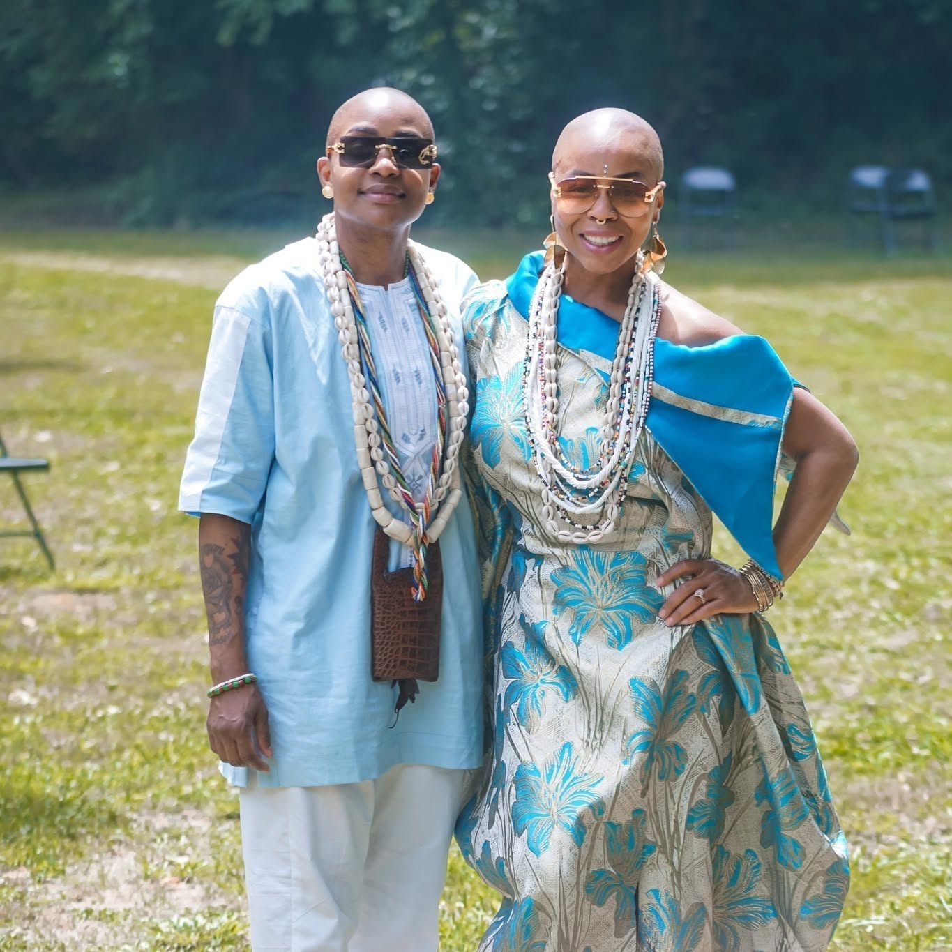 Two Ife Cultural Arts Center community members wearing blue and traditional beadwork outdoors