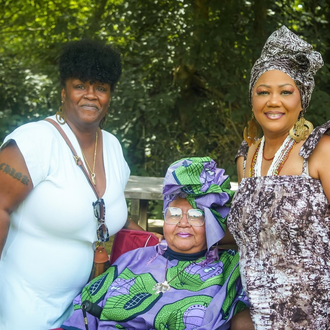 Ife Cultural Arts Center community members gathered outdoors in colorful clothing and headwraps